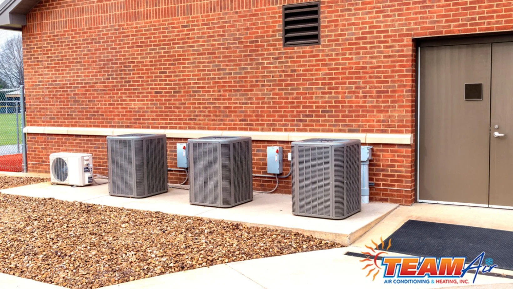 Technicians servicing commercial HVAC equipment in Clermont FL during professional AC repair for a local business facility